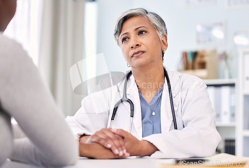 Image of Medical, holding hands and doctor with woman in clinic for support. empathy or care. Checkup, discussion and closeup of female healthcare worker with sympathy for patient in medicare hospital.