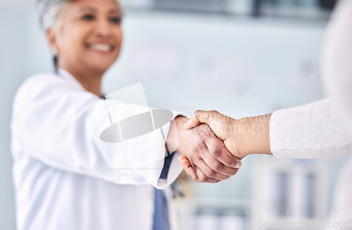 Image of Doctor, patient and handshake in partnership, meeting or deal for healthcare agreement at hospital. Happy medical professional shaking hands or person in thank you, welcome or introduction at clinic