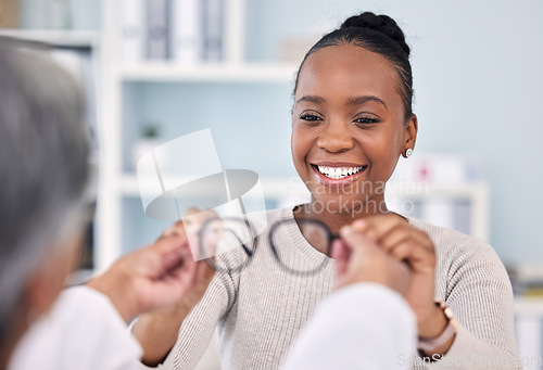 Image of Black woman, patient and doctor with glasses, eye care and vision consultation with optometrist, appointment and choice. Prescription lens, frame and help with smile, advice and optometry healthcare