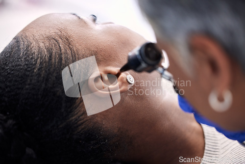 Image of Healthcare, doctor or woman for hearing consultation from infection or ear problem with otoscope at clinic. Otolaryngology, professional and black person for medical exam, test or patient for checkup