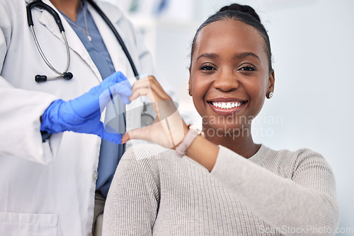 Image of Black woman, patient and doctor with smile, consultation and heart emoji for cardio health, checkup and appointment. Happiness, support and wellness for medicine, healthcare and physical examination