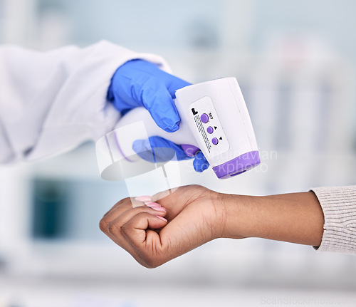 Image of Doctor, hands and thermometer for patient temperature, fever or checkup appointment at hospital. Closeup of medical nurse or surgeon checking customer with infrared scanner for virus or flu at clinic