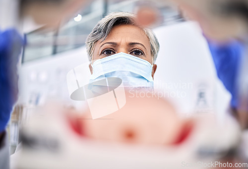 Image of Medical, surgery and blur of doctor in emergency in a operation room or hospital for medicine and with face mask. Healthcare, theatre and professional surgeon doing treatment or exam on injury