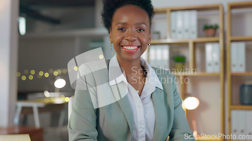 Image of Portrait, smile and business black woman manager in an office at night for corporate or professional work. Management, leadership and evening with a happy young CEO or boss in a suit at the workplace