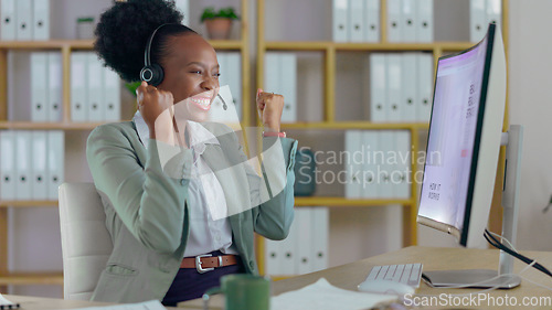 Image of Excited black woman, call center and fist pump in winning, promotion or success for customer service at office. Happy African female person, consultant or agent smile in celebration for online bonus