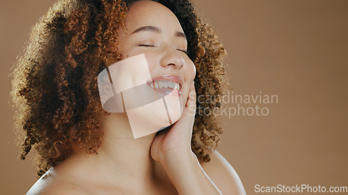 Image of Face of happy woman, natural beauty mockup space or cosmetics for wellness in studio with smile. Skin glow, pride or confident biracial female model with skincare results isolated on brown background