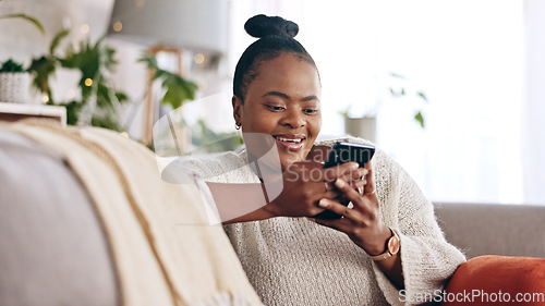 Image of Black woman, reading and using phone with smile in home or social media, mobile app and communication online. Funny, meme or person on couch streaming video or typing on cellphone in living room