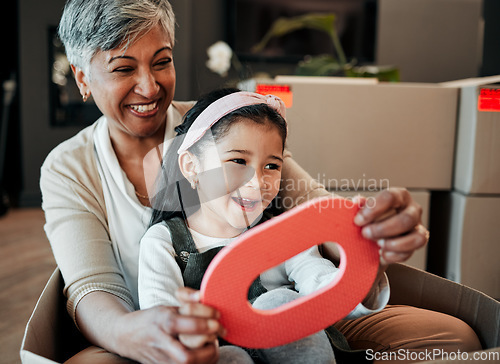 Image of Senior woman, kid and moving boxes with smile, playing and happy with grandmother, grandchild or new property. Family home, excited and enjoying at house, driving and bonding for memories, fun or joy