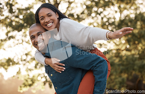 Image of Couple, park and piggy back with smile, portrait and airplane game in nature, holiday and bonding in summer. Man, woman and playful in backyard, freedom and vacation by trees with love in sunshine