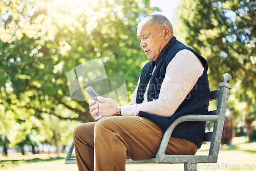 Image of Senior man, garden and browsing on phone for social media, learning and network with internet or technology on park bench, nature and outdoors. Elderly person, email and chat on smartphone or mobile