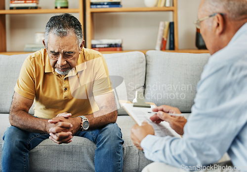 Image of Senior man talking to a therapist at a mental health, psychology and therapy clinic for session. Psychologist with clipboard for counseling checklist with elderly male patient in retirement in office