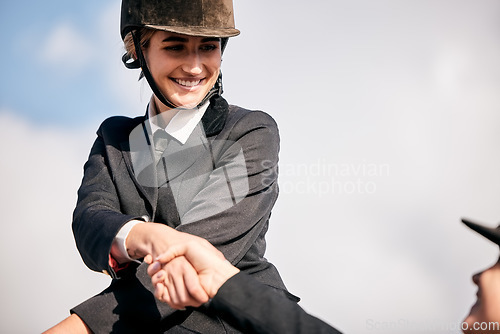 Image of Handshake, equestrian and woman on horseback with her coach outdoor for training or practice. Smile, thank you or support with a happy young rider and teacher shaking hands for success or motivation