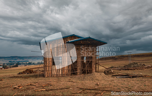 Image of Ethiopian farmer building from wood, Amhara Region, Ethiopia