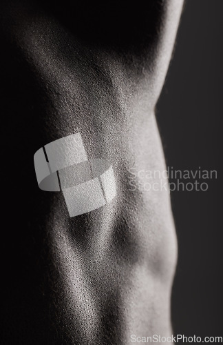 Image of Fitness, man and torso with closeup in studio for wellness, stomach and body on dark background. Person, muscle or bodybuilder with six pack for healthy lifestyle and strength for abdomen or topless