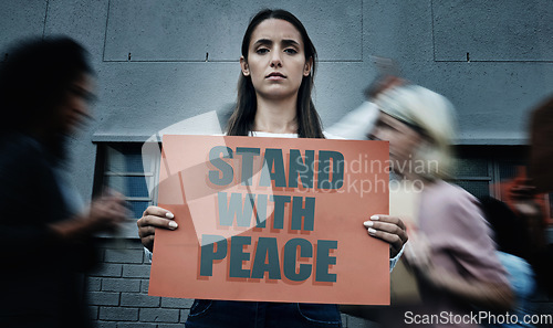 Image of Portrait, city and a woman with a sign at a protest for justice, social change or peace. Law, support and a serious person with a banner or board for government problem, human rights or a rally