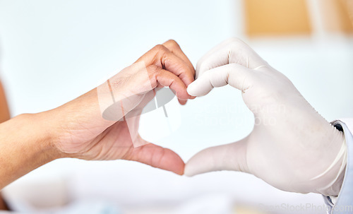 Image of Healthcare, cardiology or heart hands with a doctor and patient closeup in a hospital for love or support. Medical, health or trust with a medicine professional and resident in a clinic for wellness