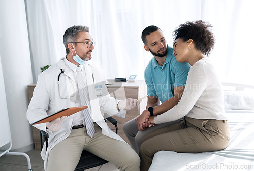 Image of Hospital, doctor and couple with sad news for medical service, comfort and empathy for diagnosis. Healthcare, consulting and person with man and woman holding hands for support, wellness or results