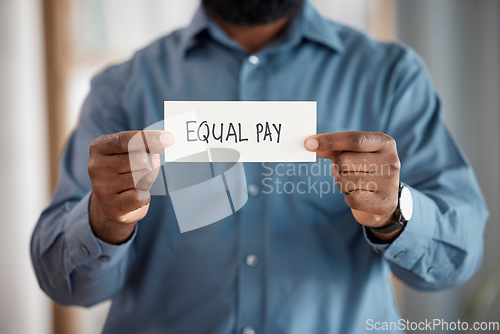 Image of Hands, paper sign and equal pay for person in office with opinion, vote and activism with promotion. Business, board or banner for gender equality, worker and human rights for salary in workplace