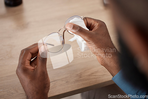 Image of Hands, glasses and fabric for cleaning, closeup and maintenance for dust, frame and eye health in home. Person, cloth and spectacles for optometry, vision and wellness for eyesight at table in house