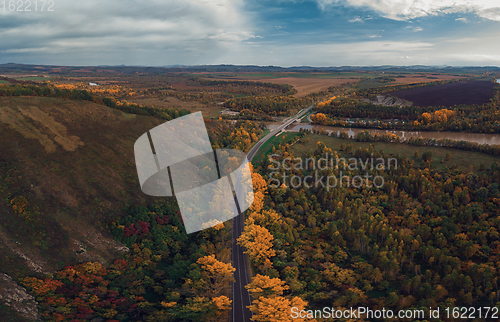 Image of Aerial view of road in beautiful autumn altai forest