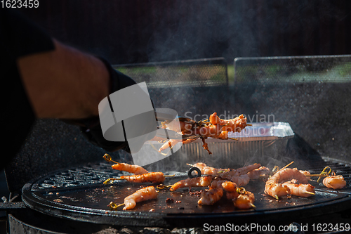 Image of A professional cook prepares shrimps