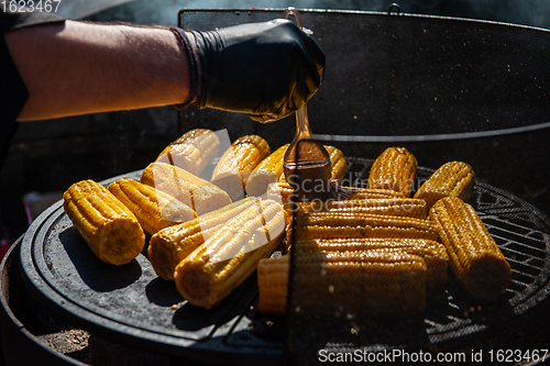 Image of A professional cook prepares corn