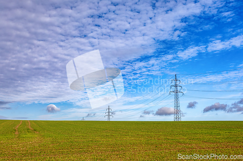 Image of High voltage power lines against a blue sky