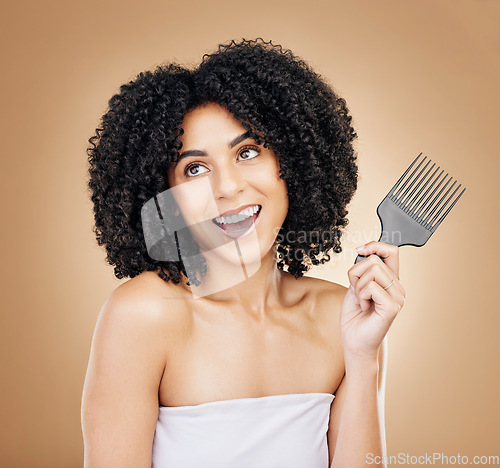Image of Hair, beauty and woman thinking with comb for style isolated in a studio brown background for wellness and skincare. Texture, natural and young person with cosmetic aesthetic in Brazil hairdresser