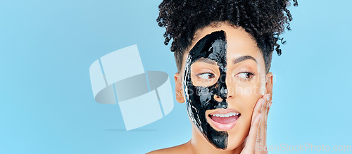 Image of Mockup, charcoal mask and face of woman for facial treatment, anti aging detox and wellness in studio. Beauty, salon and person for healthy skin, cosmetics and grooming on blue background space