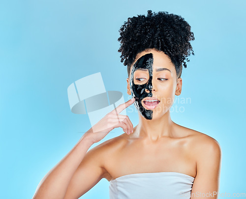 Image of Skincare, charcoal mask and face of woman for facial treatment, anti aging and wellness in studio. Beauty mockup, dermatology and person for healthy skin, cosmetics and grooming on blue background