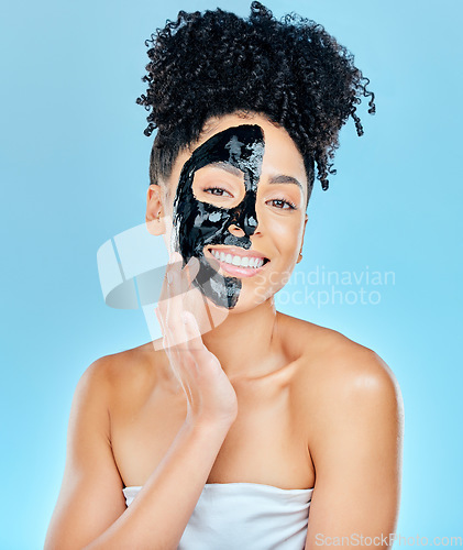 Image of Skincare, charcoal face mask and portrait of woman for facial treatment, anti aging and wellness. Beauty, studio and happy person with products for health, cosmetics or grooming on blue background