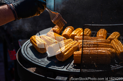 Image of A professional cook prepares corn