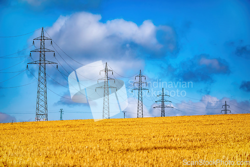 Image of High voltage power lines against a blue sky