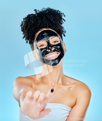 Image of Skincare, face mask and portrait of woman with finger for facial treatment, anti aging or wellness. Beauty, studio and happy person apply products for health, cosmetics or grooming on blue background