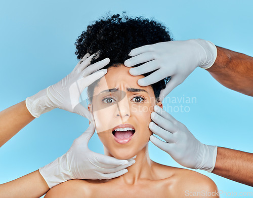 Image of Skincare, portrait of scared woman with hands on face in studio for plastic surgery consultation. Model with stress, fear and anxiety for beauty, dermatology or collagen therapy on blue background.