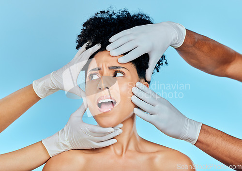 Image of Skincare, hands with gloves and woman scared in studio for facial plastic surgery consultation. Model with stress, fear and anxiety for beauty, dermatology or collagen therapy on blue background.