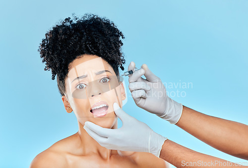 Image of Filler, portrait of scared woman with hands on face in studio for collagen skincare consultation. Model with stress, fear and anxiety for beauty, dermatology or cosmetic process on blue background.