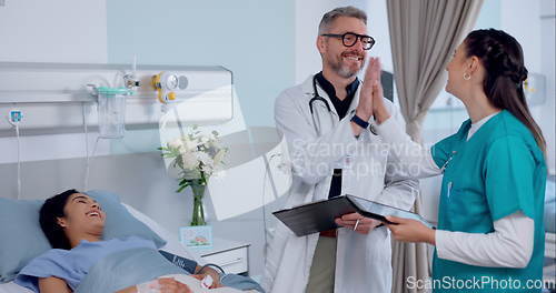 Image of Happy man, doctor and high five with patient in success for healthcare or discharge on hospital bed. Male person, nurse or medical team touching hands in teamwork for diagnosis or results at clinic