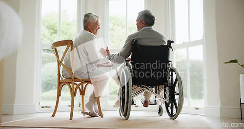 Image of Wheelchair, senior couple and conversation in a retirement and nursing home with support and holding hands. Back, love and man with a disability with speaking and discussion with empathy in marriage