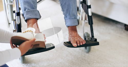 Image of Caregiver, help and shoes of patient in wheelchair, healthcare and assistance in nursing home. Nurse, closeup of hands and take off footwear of person with a disability for support of medical worker