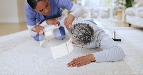 Image of Fall, accident or emergency with a nurse and old woman on the floor of an assisted living house or apartment. Healthcare, help or injury with a senior patient in her retirement home with a caregiver