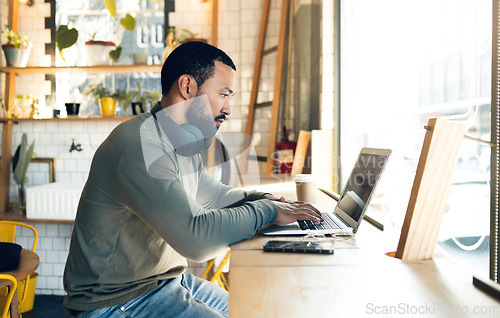 Image of Man, remote work and laptop in cafe, productivity with freelance worker and copywriter, writing article and blog. Workflow, typing on pc in coffee shop and copywriting with technology and research