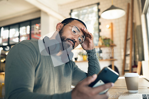 Image of Man, phone and headache in coffee shop for remote work, job search or bad news of financial fail, debt or loan. African person with stress, worry or confused reading information on his mobile at cafe
