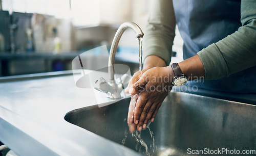 Image of Water, safety and washing hands in the kitchen with a person by the sink for skincare or wellness. Cleaning, hygiene and bacteria with an adult closeup in the home to rinse for skin protection