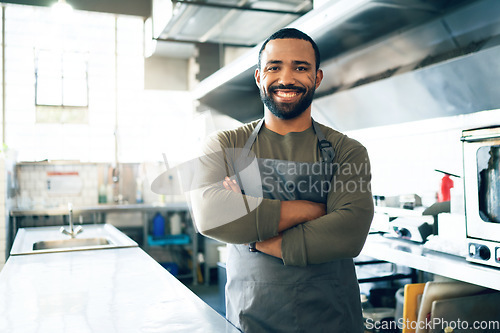 Image of Happy man, chef and small business owner in kitchen at restaurant for hospitality service, cooking or food. Portrait of male person, employee or waiter smile in confidence for professional culinary