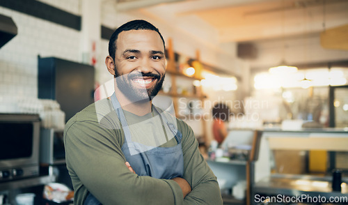 Image of Happy man, portrait and small business owner with arms crossed in kitchen for hospitality service, cooking or food. Face of male person, employee or waiter smile in confidence of professional chef