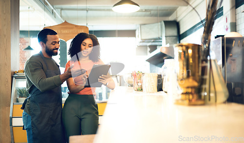 Image of Coffee shop, teamwork and man with a woman and tablet for online orders, retail information and advice. Happy, ecommerce and a business owner with a waiter and technology reading review on the web