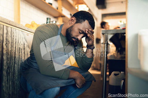 Image of Waiter man, coffee shop and tired with stress, headache or regret for mistake, fail or fatigue at job. Barista person, burnout and pain in head with anxiety, mental health or depression in restaurant