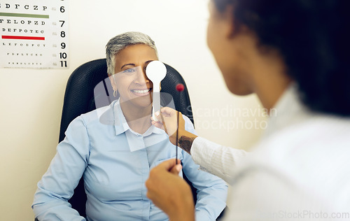 Image of Eye exam, woman and optometrist with cover for vision, healthcare and tool for focus or test at optometry. Eyes assessment, ophthalmology and person for medical support, glaucoma or retina testing