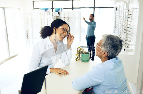 Image of Optometry, consulting or happy woman with glasses for vision in a retail optical or eyewear store. Shopping, talking or biracial customer with new spectacles or senior optometrist at optics clinic